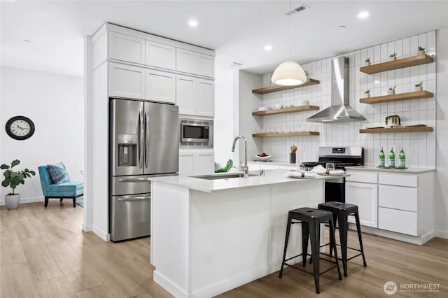 189 Countryman Dr, Monroe, WA 98272 - kitchen featuring wall chimney range hood, appliances with stainless steel finishes, open shelves, backsplash, and a sink