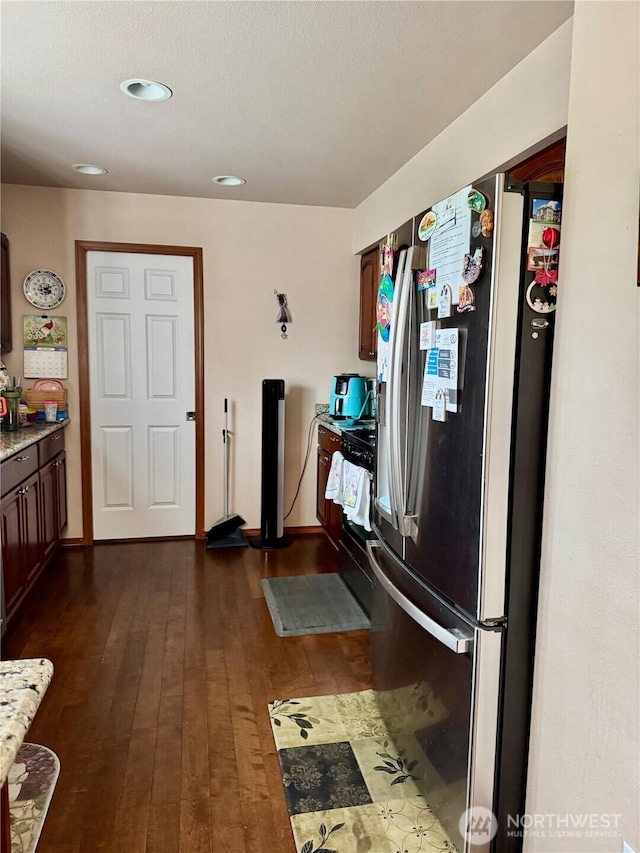 5001 S 122nd Ln, Tukwila, WA 98178 - kitchen featuring stainless steel refrigerator with ice dispenser, black range, dark wood finished floors, recessed lighting, and baseboards