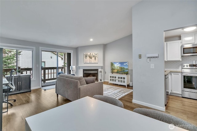 17311 119th Ln SE Unit J4, Renton, WA 98058 - living room with baseboards, wood finished floors, a fireplace, and recessed lighting