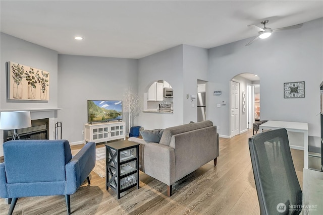 17311 119th Ln SE Unit J4, Renton, WA 98058 - living room featuring arched walkways, a ceiling fan, light wood-type flooring, lofted ceiling, and recessed lighting