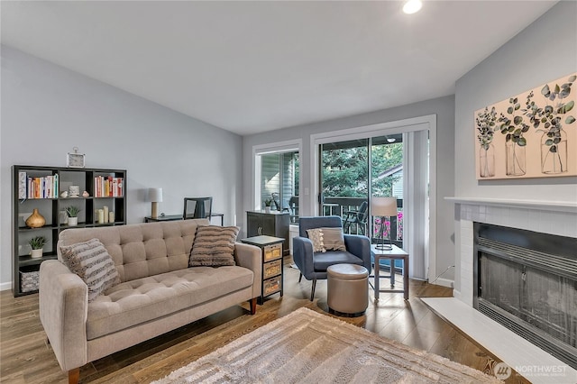 17311 119th Ln SE Unit J4, Renton, WA 98058 - living area featuring wood finished floors, a fireplace with raised hearth, recessed lighting, and baseboards