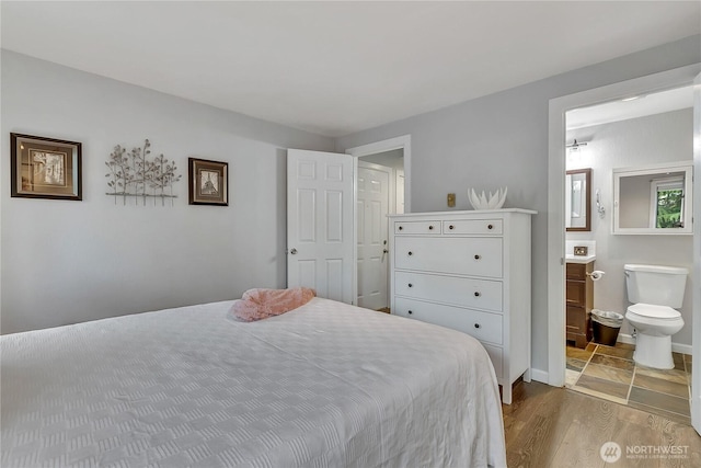17311 119th Ln SE Unit J4, Renton, WA 98058 - bedroom with wood finished floors, ensuite bathroom, and baseboards