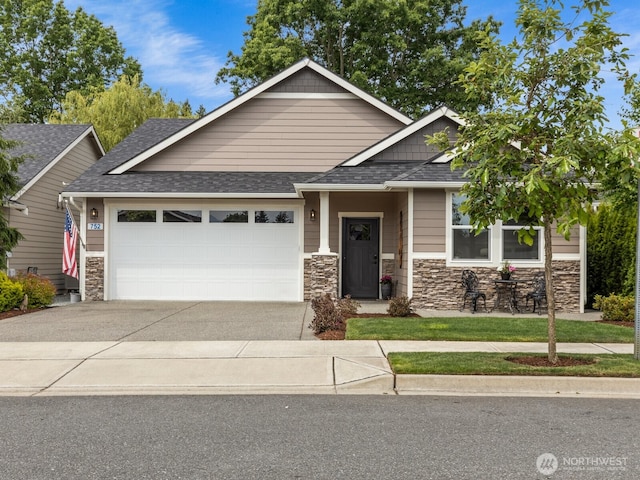 752 Parkland Loop, Sedro Woolley, WA 98284 - craftsman-style home with an attached garage, stone siding, roof with shingles, and driveway