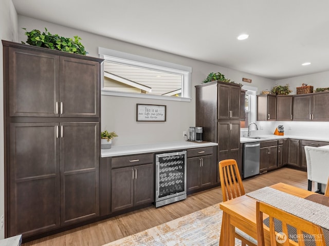 752 Parkland Loop, Sedro Woolley, WA 98284 - kitchen featuring beverage cooler, dishwasher, dark brown cabinetry, light wood-style flooring, and light countertops