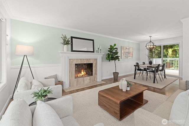 19203 Whitman Ave N, Shoreline, WA 98133 - living area featuring wood finished floors, a fireplace, ornamental molding, and a chandelier