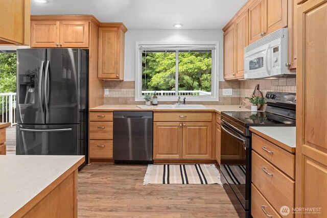19203 Whitman Ave N, Shoreline, WA 98133 - kitchen featuring stainless steel appliances, a sink, light countertops, decorative backsplash, and recessed lighting