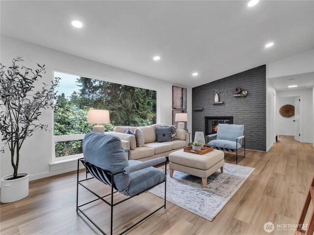 16112 Densmore Ave N, Shoreline, WA 98133 - living area featuring healthy amount of natural light, vaulted ceiling, light wood finished floors, recessed lighting, and a fireplace
