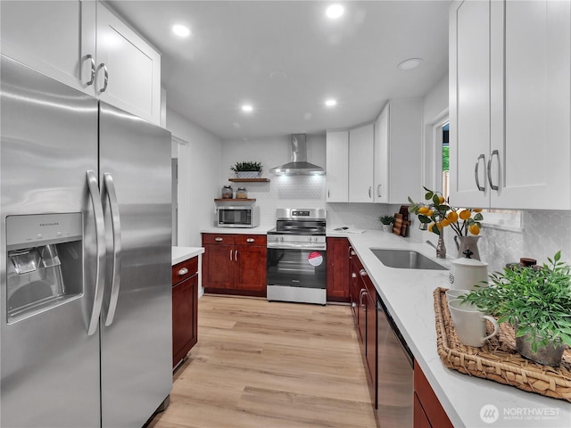16112 Densmore Ave N, Shoreline, WA 98133 - kitchen featuring stainless steel appliances, wall chimney exhaust hood, a sink, decorative backsplash, and recessed lighting