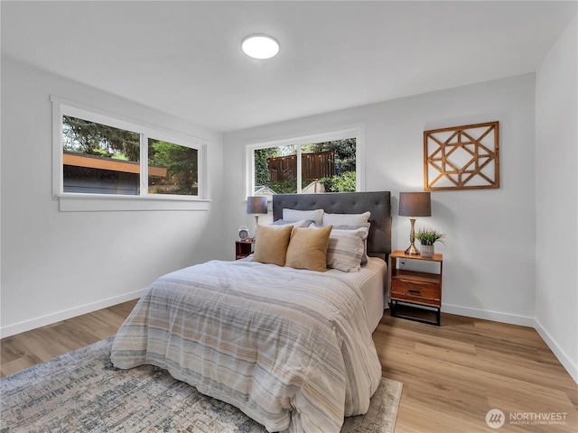 16112 Densmore Ave N, Shoreline, WA 98133 - bedroom with multiple windows, wood finished floors, and baseboards