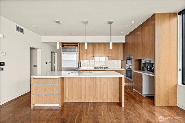 302 N Stadium Way Unit 302, Tacoma, WA 98403 - kitchen featuring modern cabinets, a sink, built in refrigerator, dark wood-style floors, and recessed lighting