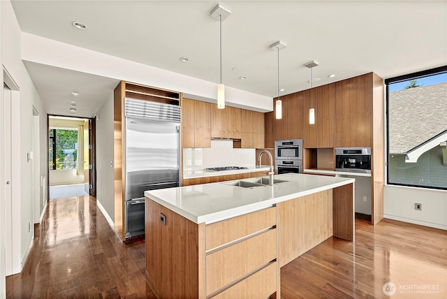 302 N Stadium Way Unit 302, Tacoma, WA 98403 - kitchen with stainless steel appliances, modern cabinets, a sink, dark wood-style floors, and recessed lighting