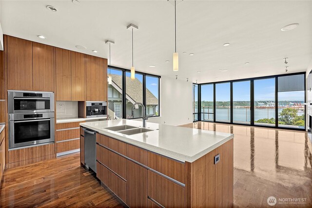 302 N Stadium Way Unit 302, Tacoma, WA 98403 - kitchen with modern cabinets, a sink, appliances with stainless steel finishes, brown cabinetry, and recessed lighting