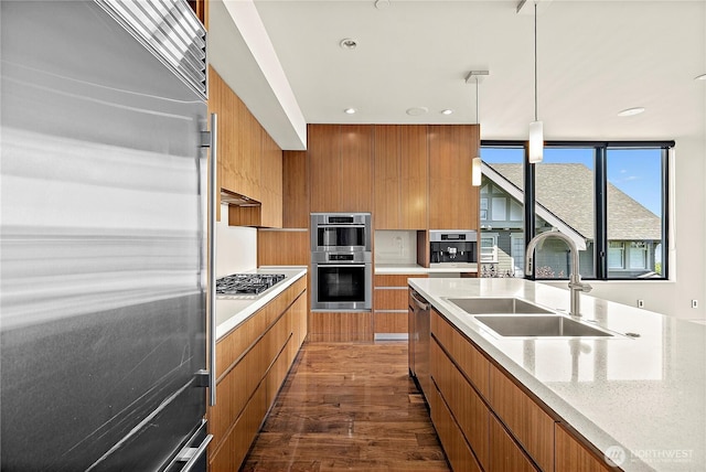 302 N Stadium Way Unit 302, Tacoma, WA 98403 - kitchen featuring stainless steel appliances, modern cabinets, brown cabinets, a sink, and dark wood-style floors