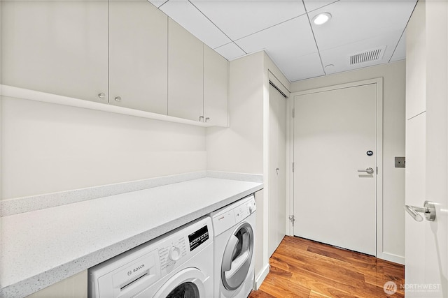 302 N Stadium Way Unit 302, Tacoma, WA 98403 - laundry room featuring washer and dryer, cabinet space, light wood finished floors, and recessed lighting