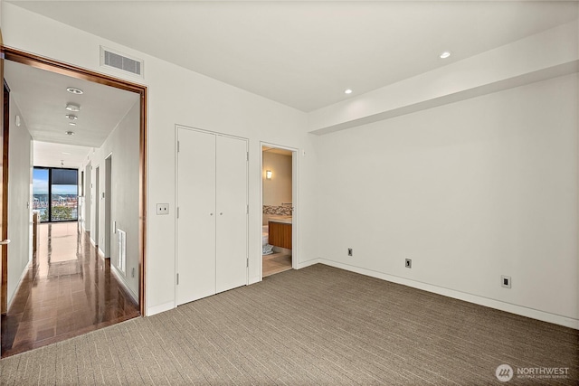 302 N Stadium Way Unit 302, Tacoma, WA 98403 - unfurnished bedroom featuring recessed lighting, carpet, ensuite bath, and baseboards