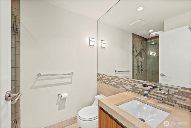 302 N Stadium Way Unit 302, Tacoma, WA 98403 - bathroom with toilet, a shower stall, vanity, recessed lighting, and backsplash