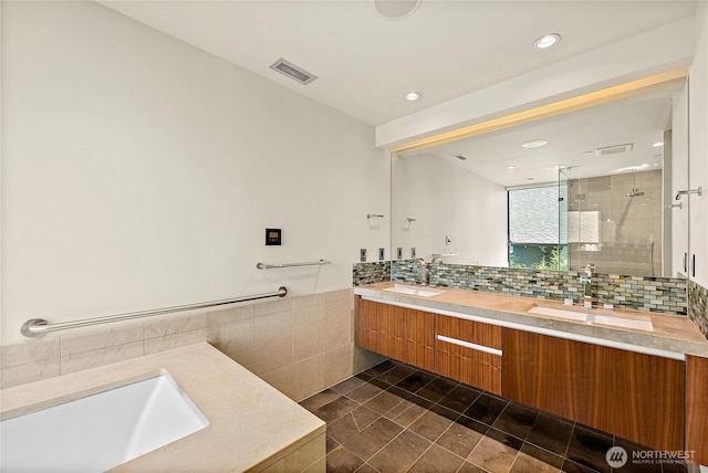 302 N Stadium Way Unit 302, Tacoma, WA 98403 - bathroom featuring double vanity, a stall shower, tile walls, recessed lighting, and backsplash