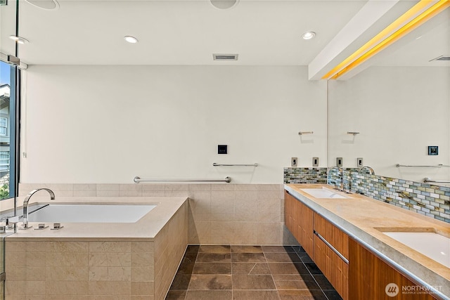 302 N Stadium Way Unit 302, Tacoma, WA 98403 - full bathroom featuring a bath, double vanity, recessed lighting, tile patterned floors, and decorative backsplash