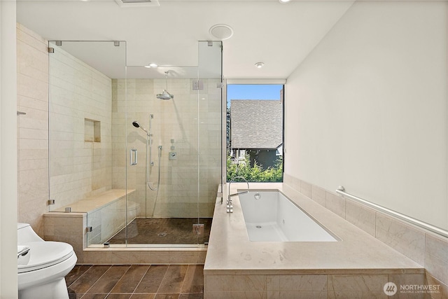 302 N Stadium Way Unit 302, Tacoma, WA 98403 - bathroom with a bath, a shower stall, toilet, and wood finished floors