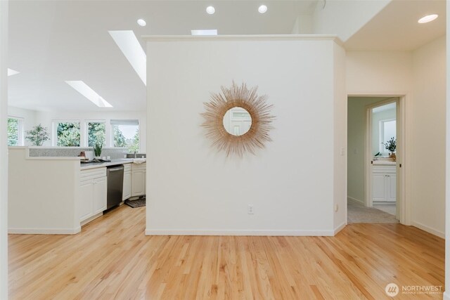 2921 Haggin St, Bellingham, WA 98226 - kitchen with a skylight, stainless steel dishwasher, light wood-style floors, light countertops, and recessed lighting