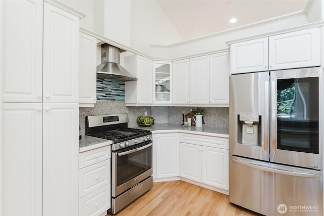 2921 Haggin St, Bellingham, WA 98226 - kitchen featuring appliances with stainless steel finishes, wall chimney exhaust hood, backsplash, light countertops, and white cabinetry