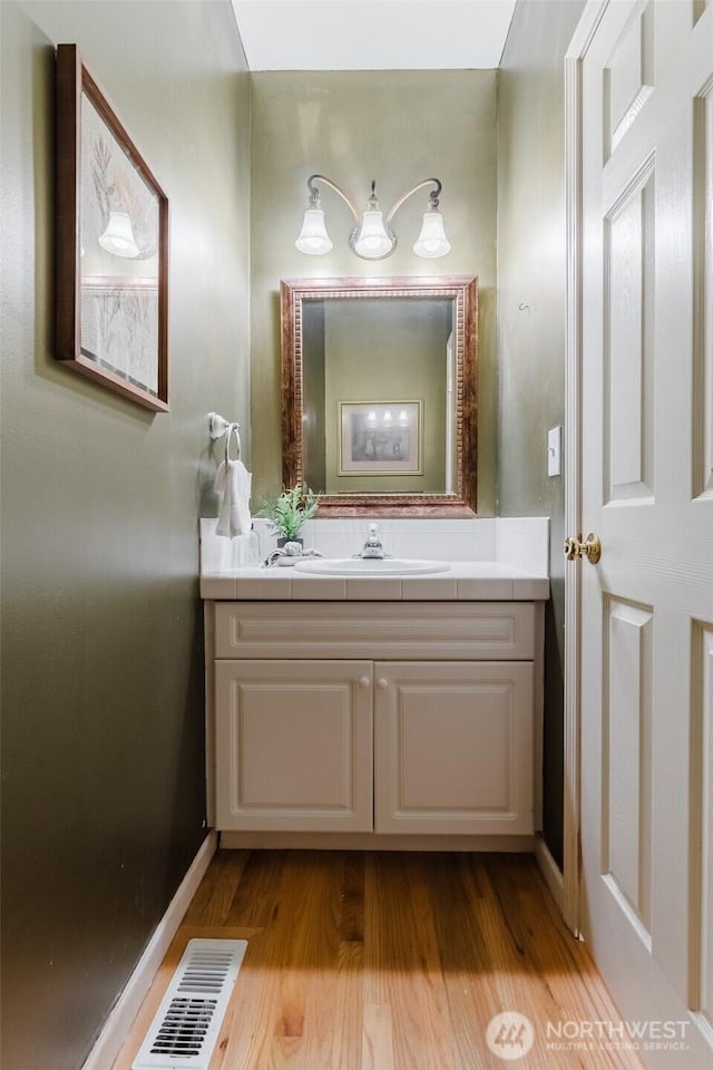 2921 Haggin St, Bellingham, WA 98226 - bathroom with vanity, wood finished floors, and baseboards