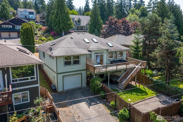 2921 Haggin St, Bellingham, WA 98226 - view of front of house with driveway, a deck, an attached garage, a fenced backyard, and stairs