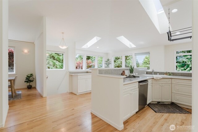 2921 Haggin St, Bellingham, WA 98226 - kitchen with a skylight, stainless steel dishwasher, plenty of natural light, and light wood finished floors