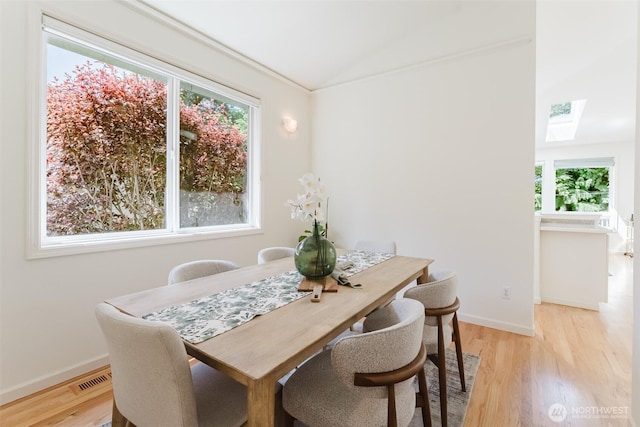 2921 Haggin St, Bellingham, WA 98226 - dining area featuring a skylight, healthy amount of natural light, light wood finished floors, lofted ceiling, and baseboards