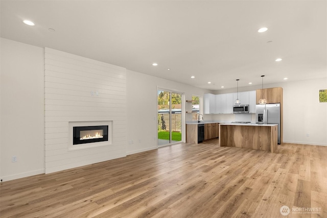 116 4th Ave S, Algona, WA 98001 - kitchen with open floor plan, appliances with stainless steel finishes, recessed lighting, light countertops, and light wood-style flooring