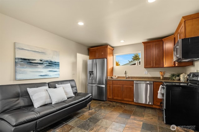 506 13th Ave W, Kirkland, WA 98033 - kitchen with stainless steel appliances, dark stone finish flooring, dark countertops, brown cabinetry, and recessed lighting