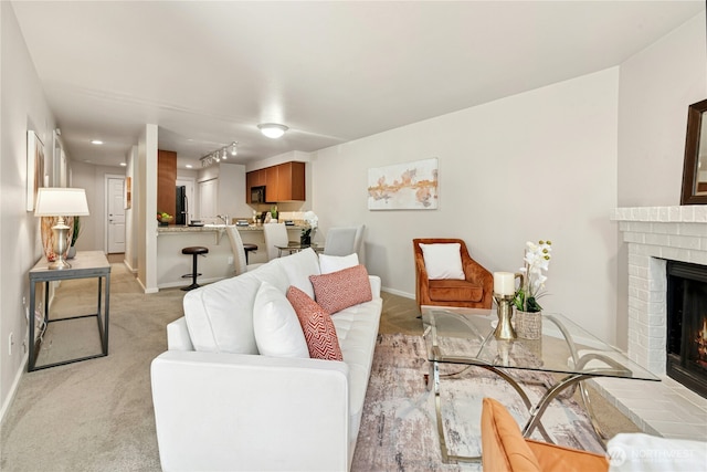 11309 NE 128th St Unit F302, Kirkland, WA 98034 - living room with a brick fireplace, light colored carpet, and baseboards