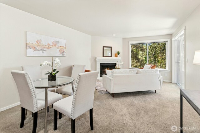11309 NE 128th St Unit F302, Kirkland, WA 98034 - dining area featuring light carpet, a brick fireplace, baseboards, and recessed lighting