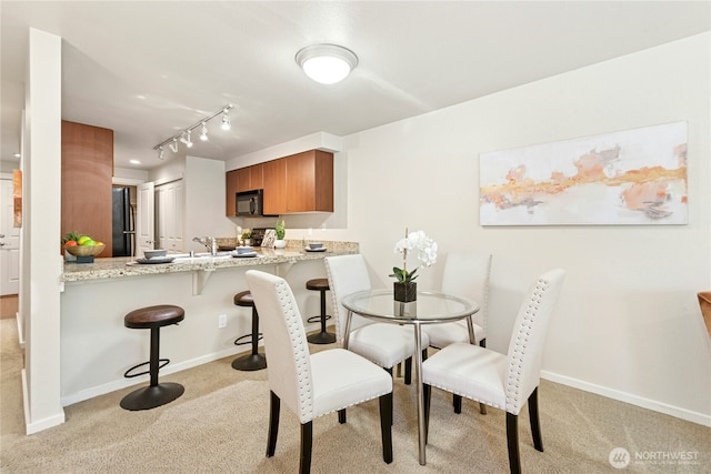 11309 NE 128th St Unit F302, Kirkland, WA 98034 - dining room featuring light carpet, baseboards, and rail lighting