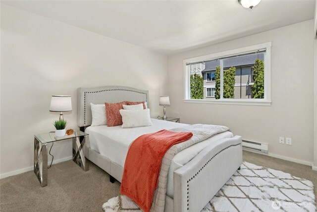11309 NE 128th St Unit F302, Kirkland, WA 98034 - carpeted bedroom featuring a baseboard heating unit and baseboards