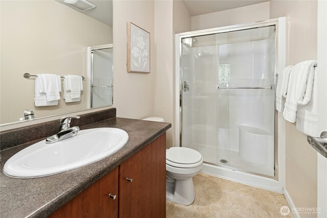 11309 NE 128th St Unit F302, Kirkland, WA 98034 - full bath with a shower stall, vanity, toilet, and tile patterned floors
