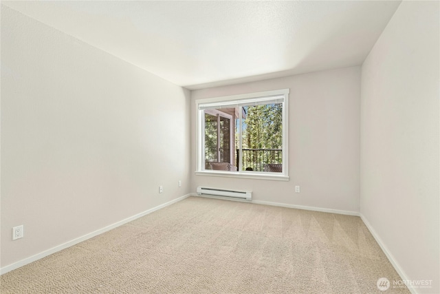 11309 NE 128th St Unit F302, Kirkland, WA 98034 - spare room featuring a baseboard radiator, carpet, and baseboards