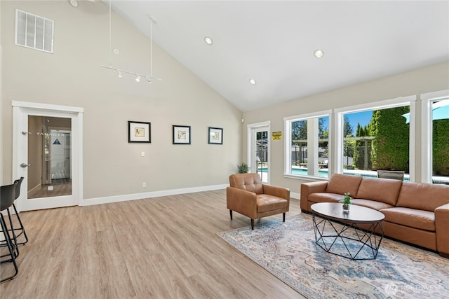 11309 NE 128th St Unit F302, Kirkland, WA 98034 - living room with high vaulted ceiling, light wood-style flooring, baseboards, and recessed lighting