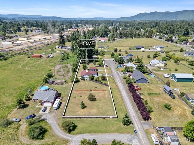 9445 181st Way SW, Rochester, WA 98579 - aerial view of property and surrounding area with property parcel outlined and a mountainous background