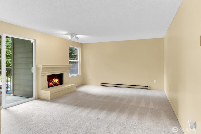 820 Cady Rd Unit H202, Everett, WA 98203 - unfurnished living room with a baseboard radiator, carpet, and a brick fireplace