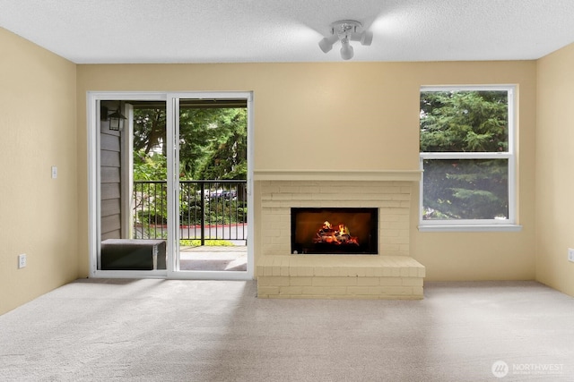 820 Cady Rd Unit H202, Everett, WA 98203 - unfurnished living room featuring carpet flooring and a brick fireplace
