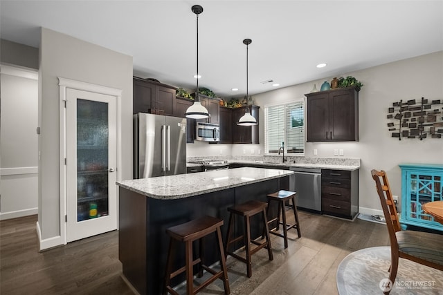 22412 SE 283rd St, Maple Valley, WA 98038 - kitchen with appliances with stainless steel finishes, dark brown cabinets, a kitchen island, dark wood-type flooring, and recessed lighting