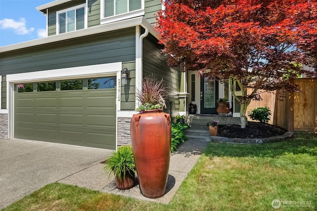 22412 SE 283rd St, Maple Valley, WA 98038 - view of home's exterior featuring driveway, stone siding, and an attached garage