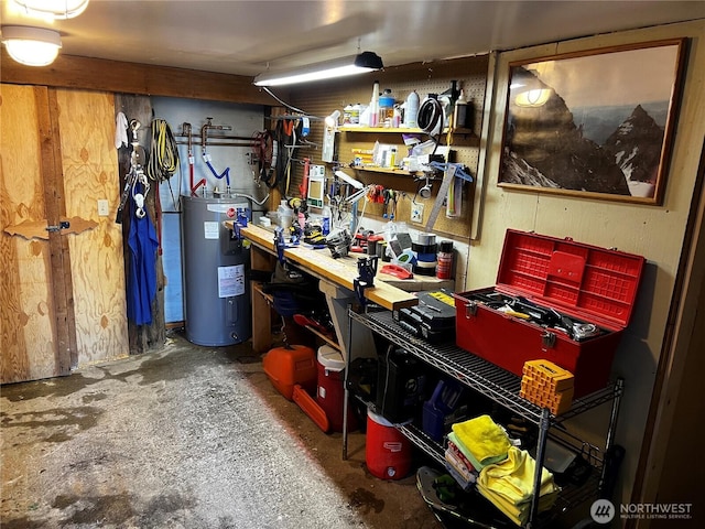 210 Gold Hill Rd, Enumclaw, WA 98022 - miscellaneous room featuring electric water heater, a workshop area, and concrete flooring