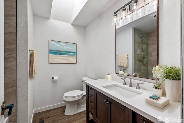 550 E Way To Tipperary, Shelton, WA 98584 - full bathroom with wood finished floors, vanity, toilet, baseboards, and tiled shower
