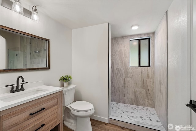 550 E Way To Tipperary, Shelton, WA 98584 - full bathroom featuring vanity, a tile shower, toilet, wood finished floors, and baseboards