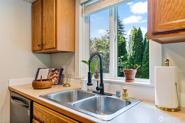 9106 1st Pl NE Unit 1, Lake Stevens, WA 98258 - kitchen featuring a sink, dishwasher, brown cabinetry, and light countertops