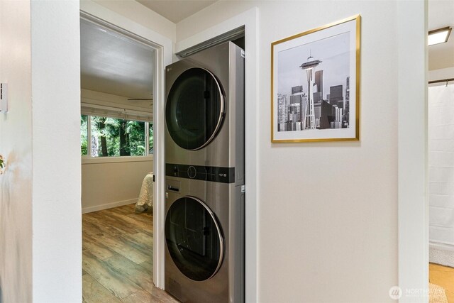 9106 1st Pl NE Unit 1, Lake Stevens, WA 98258 - washroom featuring stacked washer / dryer, wood finished floors, and baseboards