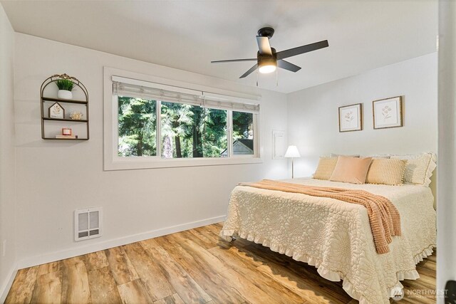 9106 1st Pl NE Unit 1, Lake Stevens, WA 98258 - bedroom with baseboards, wood finished floors, and a ceiling fan