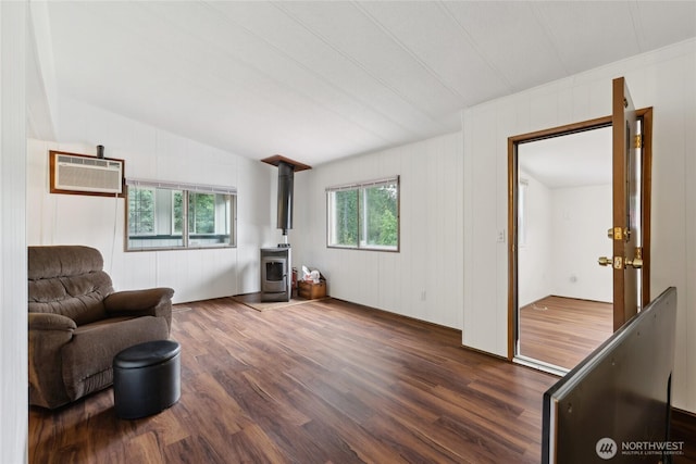 35605 158th St SE, Sultan, WA 98294 - living room featuring a wood stove, dark wood-style floors, a wall unit AC, and lofted ceiling